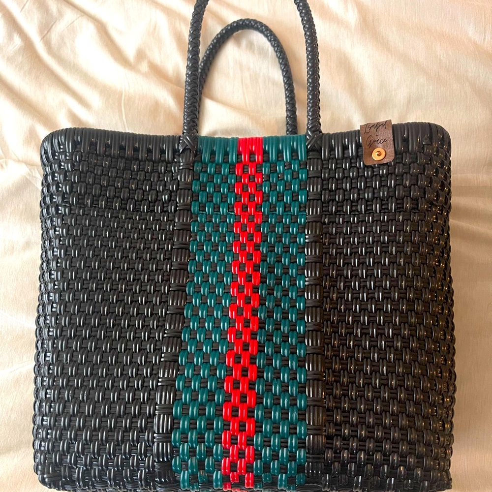Handmade woven tote made out of recycled plastic.